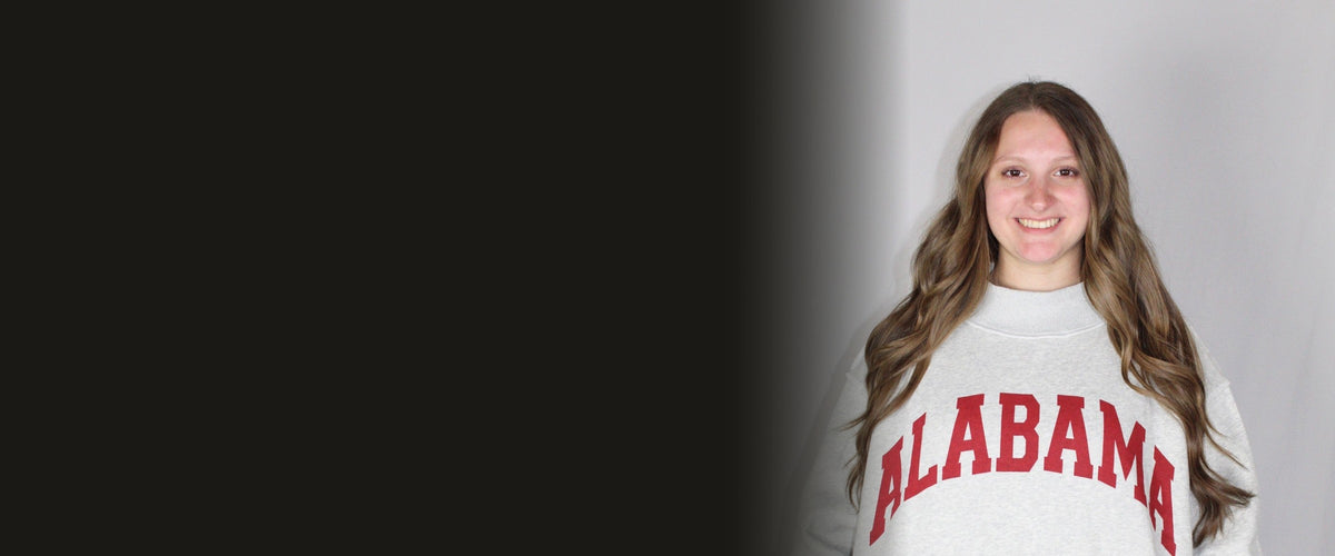Model wearing an Alabama gameday sweatshirt in store