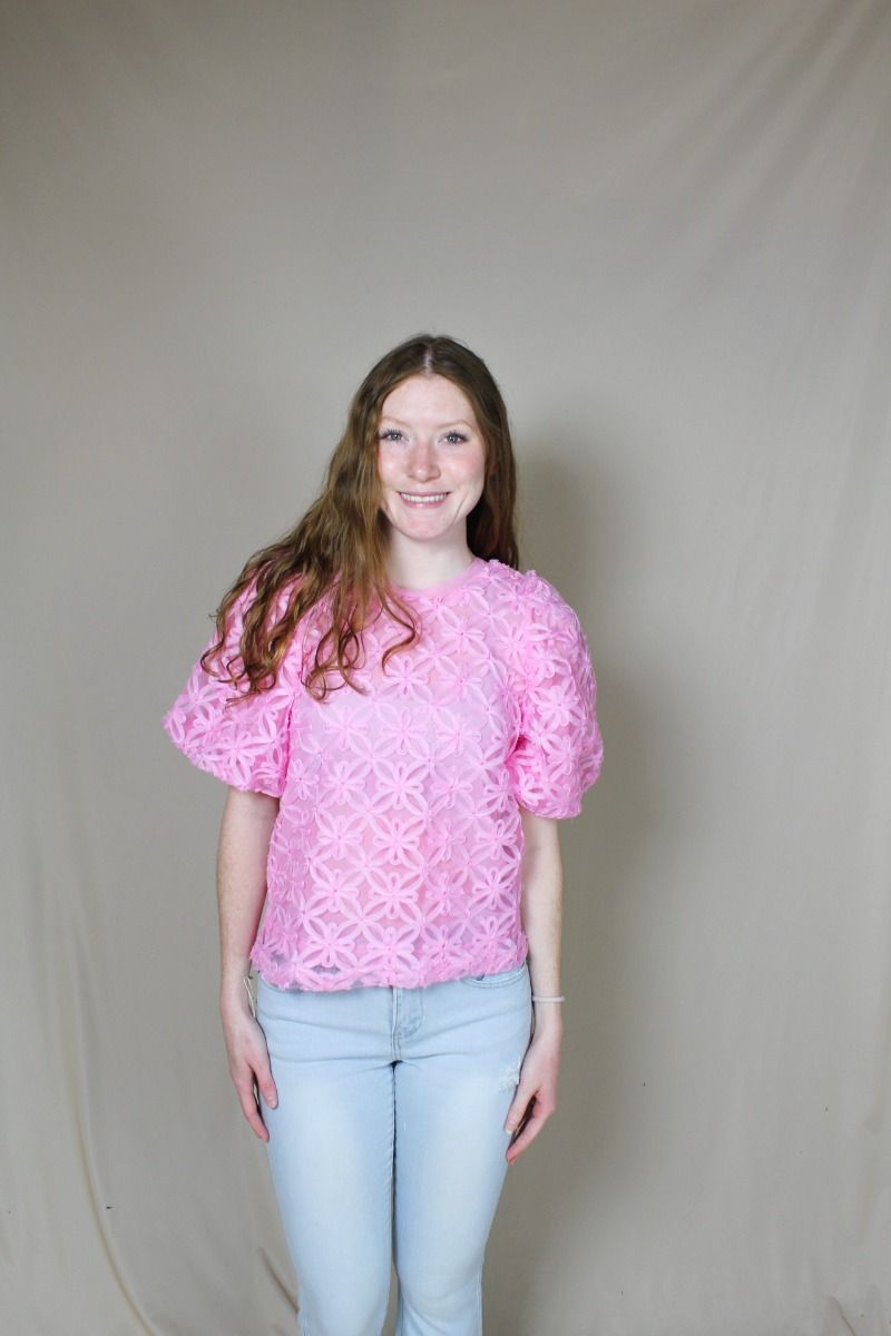 Pink flower-applique puff sleeve top on model