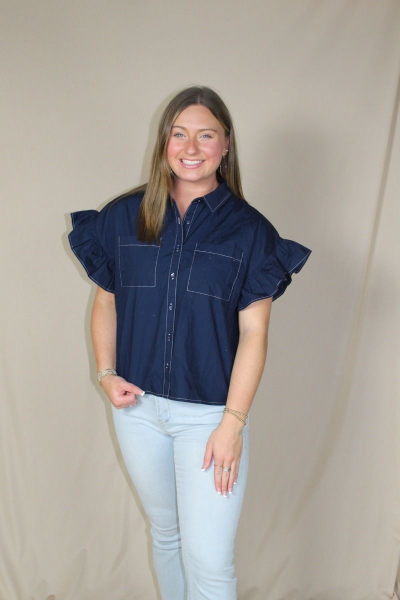 Navy ruffle-sleeve button-down top on model